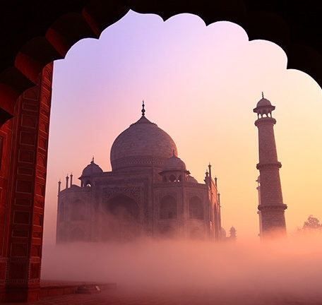 Arts, Culture & History trips - Taj Mahal in the warm pink and yellows of sunrise on a foggy morning