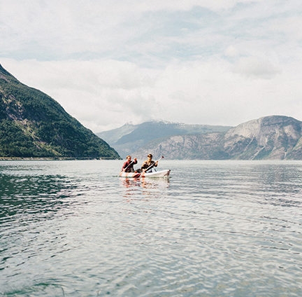 Two people canoeing in calm waters