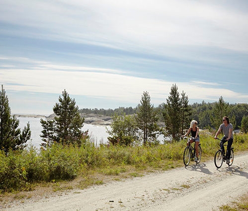Couple bicycling on rural dirt path