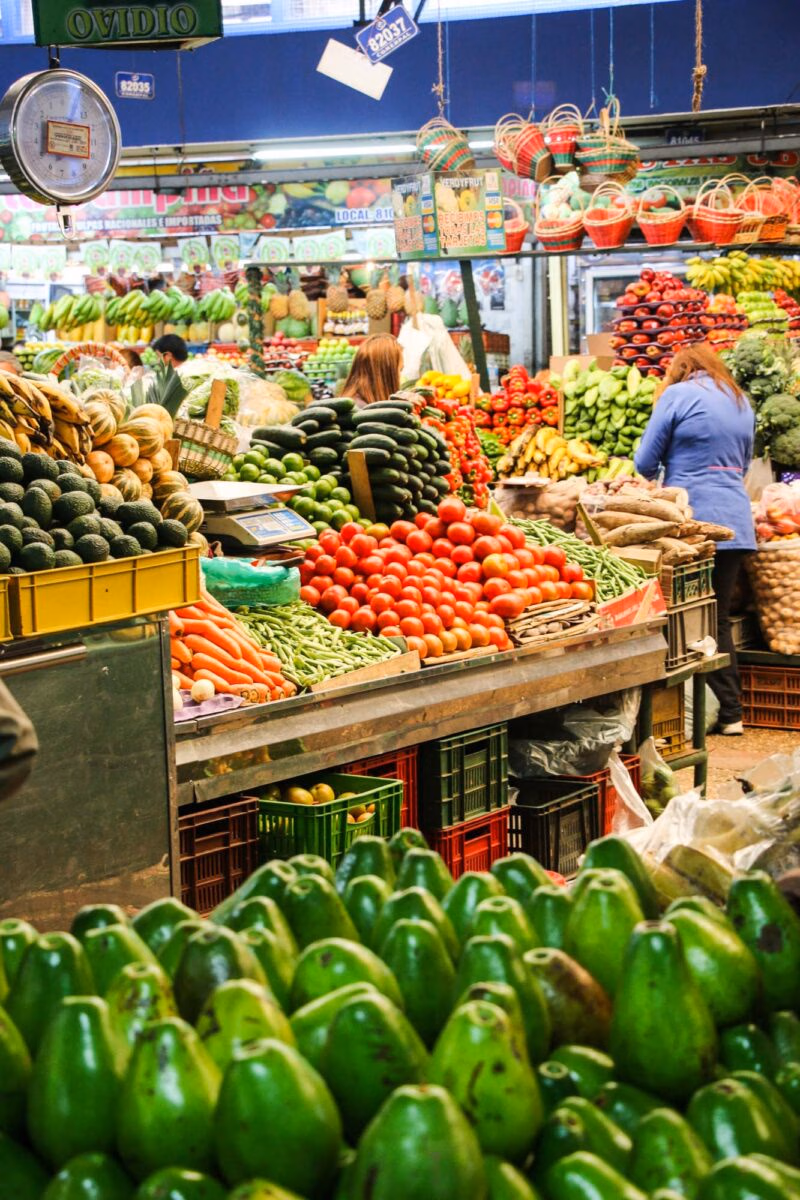 Fruit market in Colombia with trays piled high with colourful fruits and vegetables on luxury latin America tour