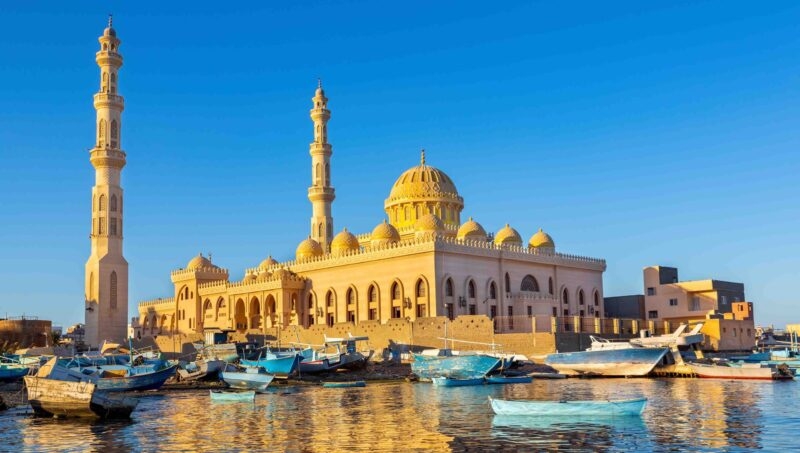 Mosque with fishing boats at sea in egypt