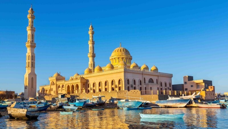 Mosque with fishing boats at sea in egypt