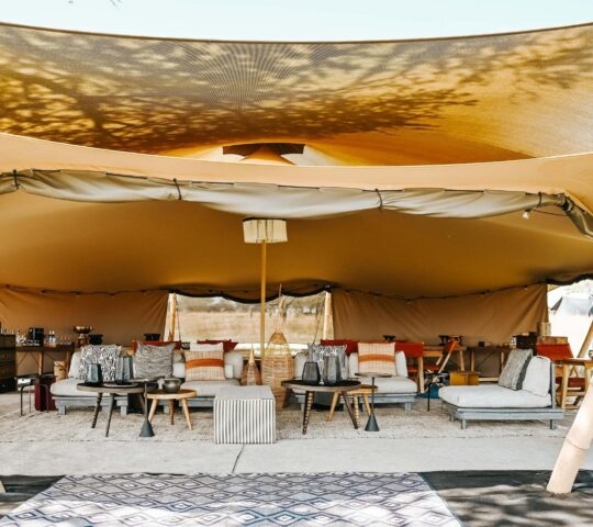 Open lounge of luxury safari camp Wilderness Usawa with sunlight and sofas, Serengeti National Park Tanzania