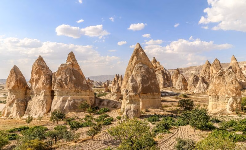 Tall, conical rock formations known as fairy chimneys viewed on luxury Turkey Asia holidays.
