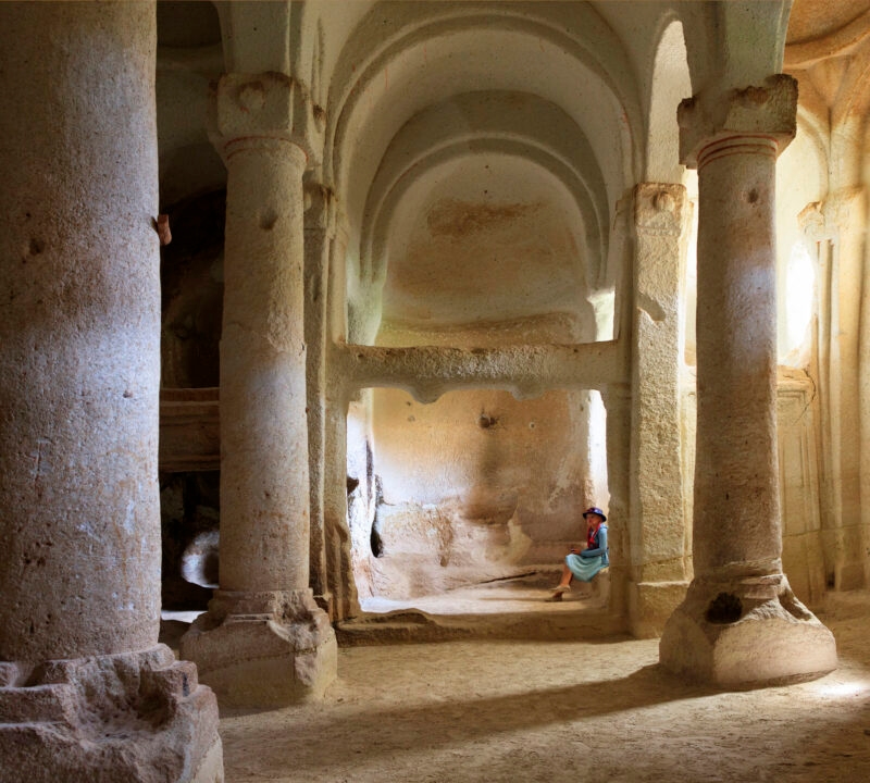 The interior of an ancient stone cave dwelling with high arches seen on luxury Turkey Asia vacations.