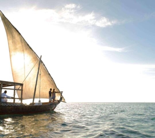A dhow boat can be seen off Mnemba Island