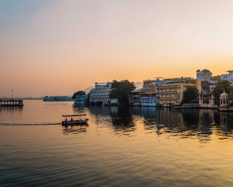 Pichola Lake in Udaipur, with a small boat on the water at sunset