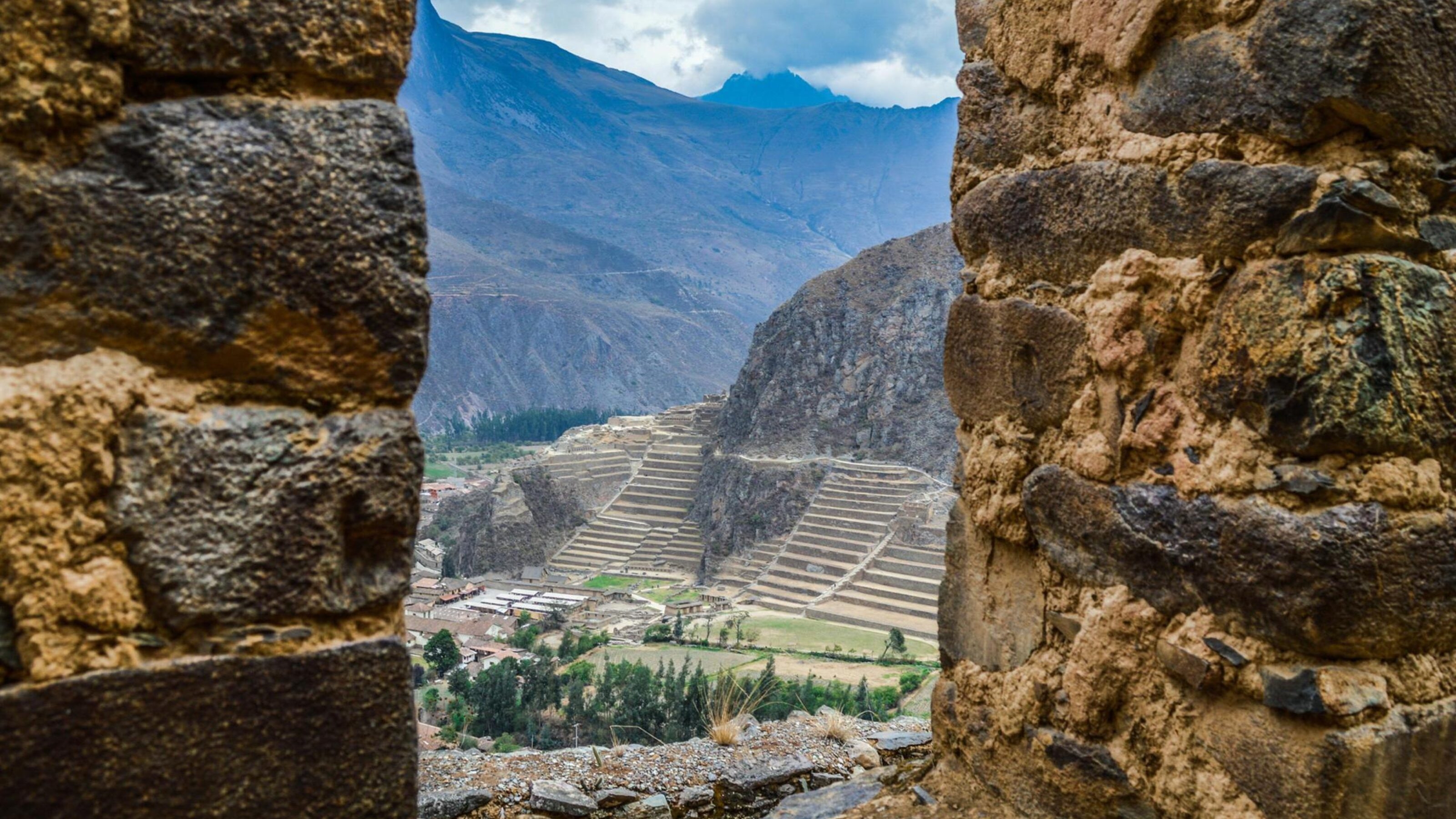 A view through a gap in the walls around Sacred Valley ruins in Peru
