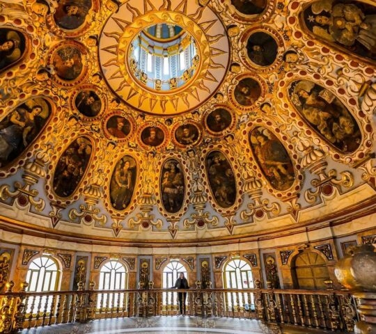 Light pours through the windows of Church la Compañía illuminating its intricately decorated dome Quito, Ecuador