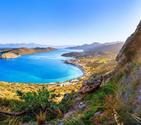 Panoramic view of the gulf of Elounda with Spinalonga island. View from the mountain through a cave, Crete, Greece.