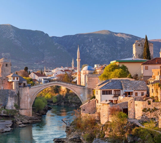 Skyline of Mostar with the Mostar Bridge, houses and minarets