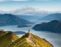 Roys peak mountain hike in Wanaka New Zealand. Popular tourism travel destination. Concept for hiking travel and adventure. Scenic view over lake from mountains peak. New Zealand landscape background.