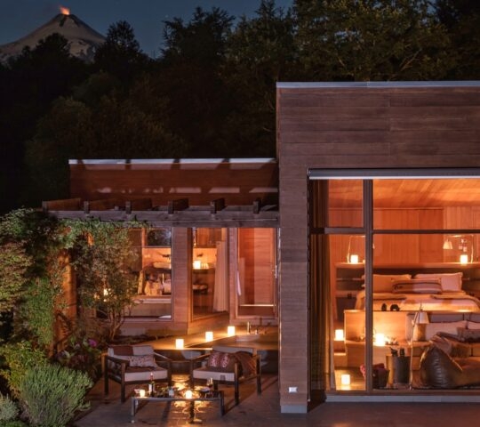 A villa lit up at night at &Beyond Vira Vira in Chile