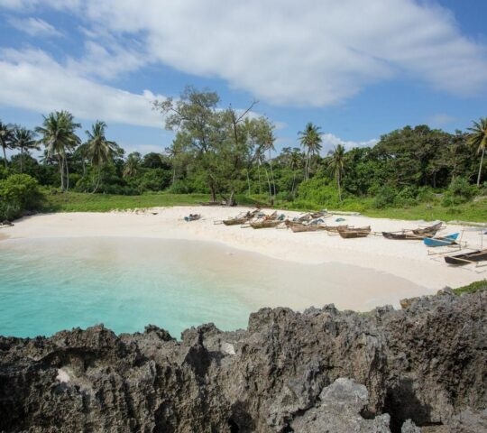 Boats anchor on the Mandorak Beach shoreline at Southwest Sumba, Indonesia