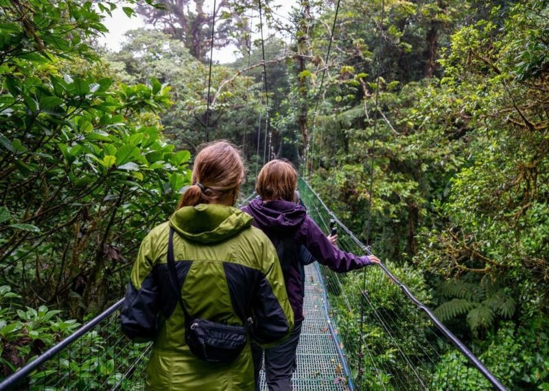 Woman and teenage girl crossing a suspension bridge in the Cloud Forest.