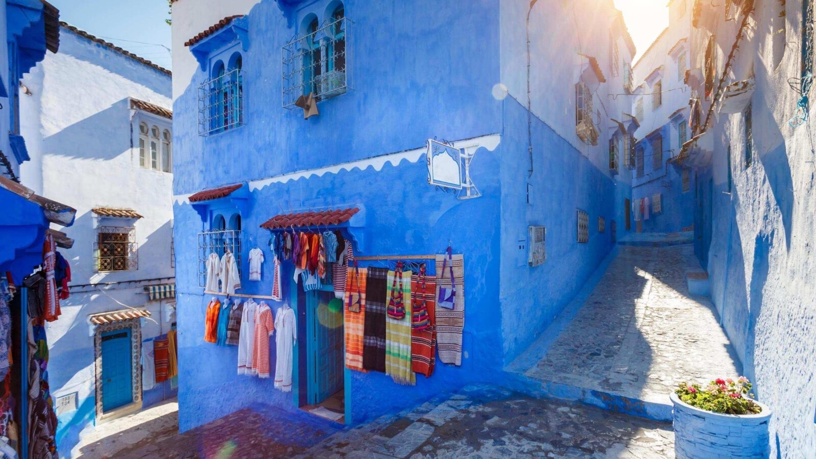 Blue building at Chafchuen at sunny day. Traditional Maroccan fabric store.