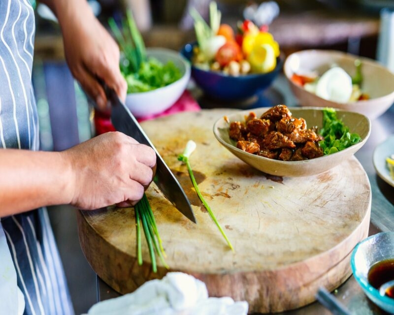 Chef making traditional cambodian meat dish at cooking class