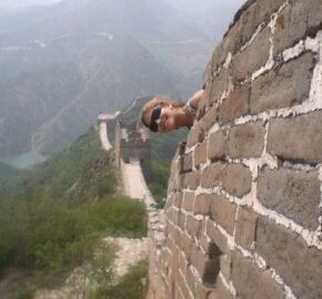 Section of the Great Wall of China overlooking mountainous terrain.