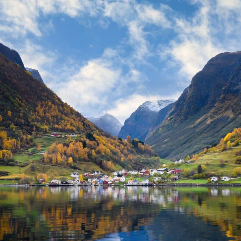 The village of Undredal is a small village on the fjord. Aurlandsfjord West coast of Norway, High mountains and villages reflect in the water during autumn season.