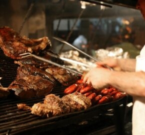 Argentinian chef cooking meat in the restaurant Chef at work