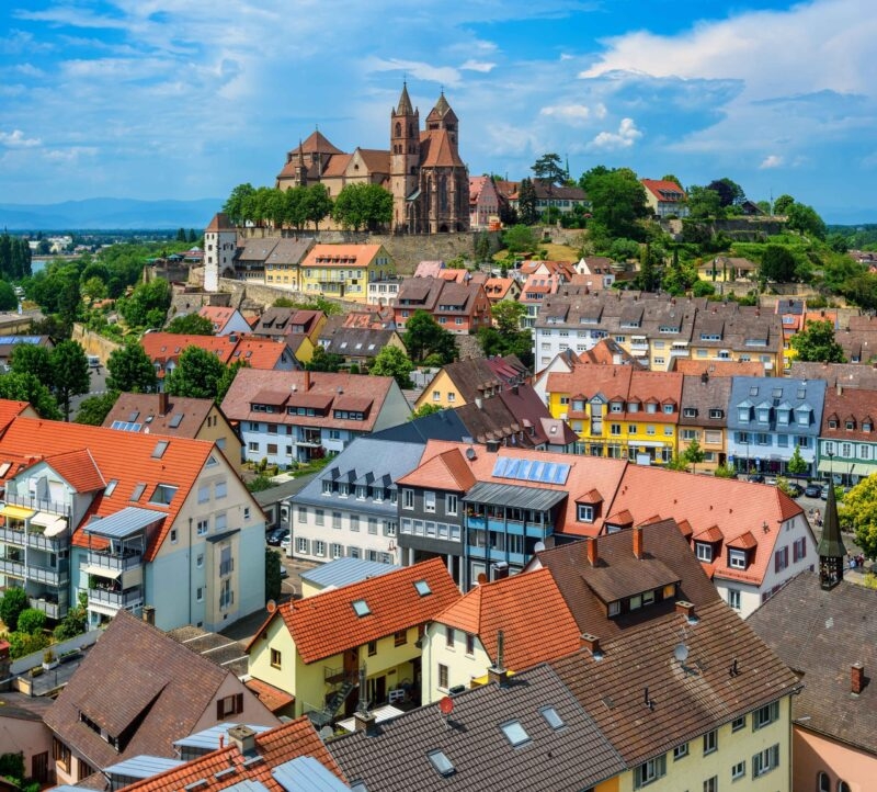 Colorful houses and the romanesque St Stephen's cathedral in the historical Old town of Breisach in the Rhine valley, Germany