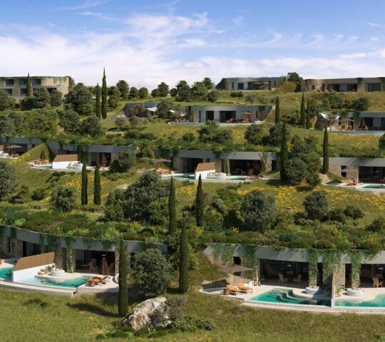 A view of Mandarin Oriental Costa Navarino's villas emerging from a leafy hillside.