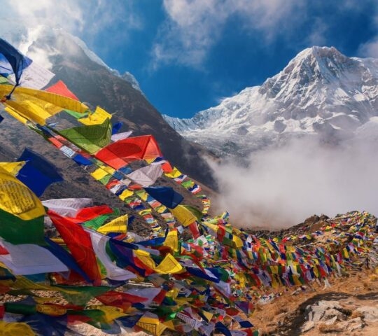 Prayer flags and Mt. Annapurna in the background in Nepal.