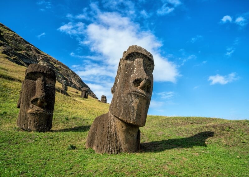 Moai statues in the Rano Raraku Volcano in Easter Island, Chile with blue sky