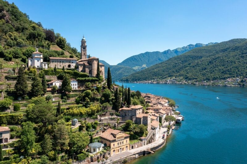 View of a village inTicino, Switzerland, next to a bright blue lake