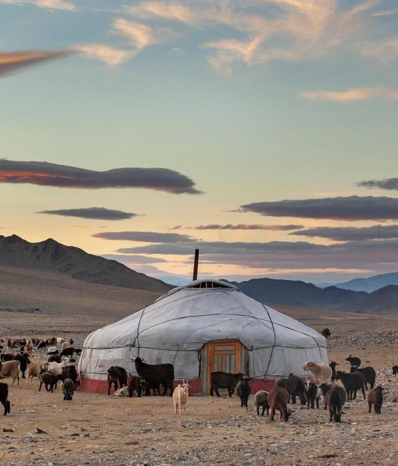 The autumn hues of Moon Bay in Xinjiang, China and a herd of goats gathered around a traditional yurt in western Mongolia.