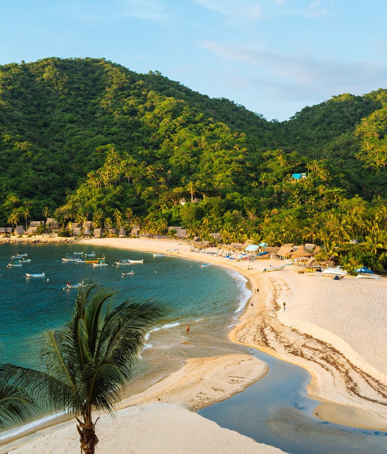 The secluded bay of Yelapa on Jalisco’s Pacific coast and an aerial view of Puerto Ángel in Oaxaca, with its rugged shoreline and the town overlooking the sea.