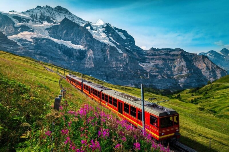 Red Jungfraujoch railway with snowy mountains in the background