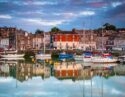 Padstow harbour with boats and buildings reflected in the harbour