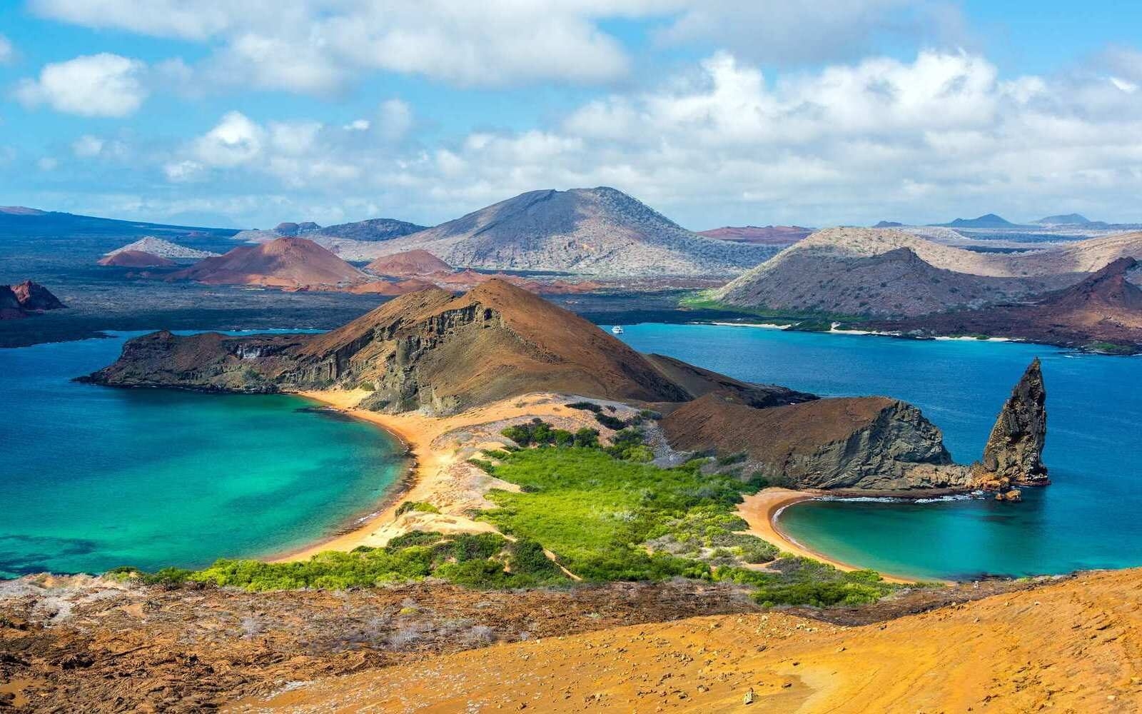 The twin beaches of Bartolomé Island, framed by volcanic peaks and turquoise waters of the Pacific Ocean in the Galápagos Islands, Ecuador.