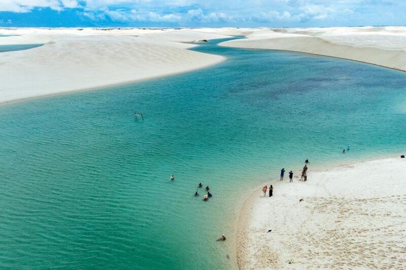 Aerial view of people swimming in one of the lagoons at Lençóis Maranhenses
