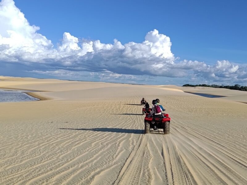 People riding ATVs on the sand dunes at Lençóis Maranhenses