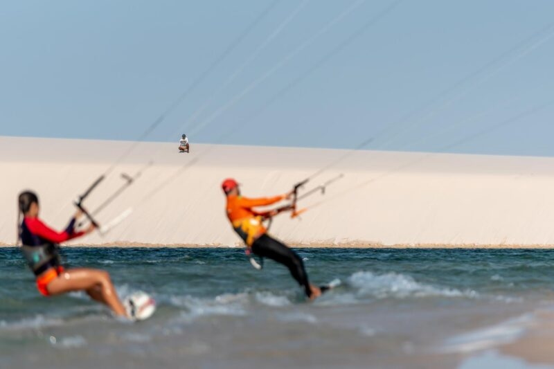 Two people kitesurfing on a lagoon at Lençóis Maranhenses