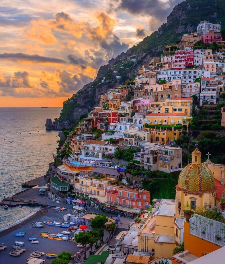 A couple enjoying a quiet gondola ride through Venice’s renowned canals and a glowing sunset over the Amalfi Coast in Positano.