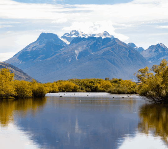 A mountain towers over a lagoon in Glenorchy, New Zealand