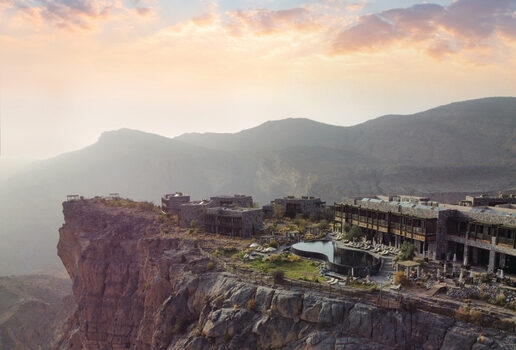 The sculpted timber form of Tierra Patagonia in Chile, the clifftop retreat of Alila Jabal Akhdar in Oman perched high above the canyon, and the serene reflection pools of Kempinski Hotel Ishtar Dead Sea in Jordan at sunset.
