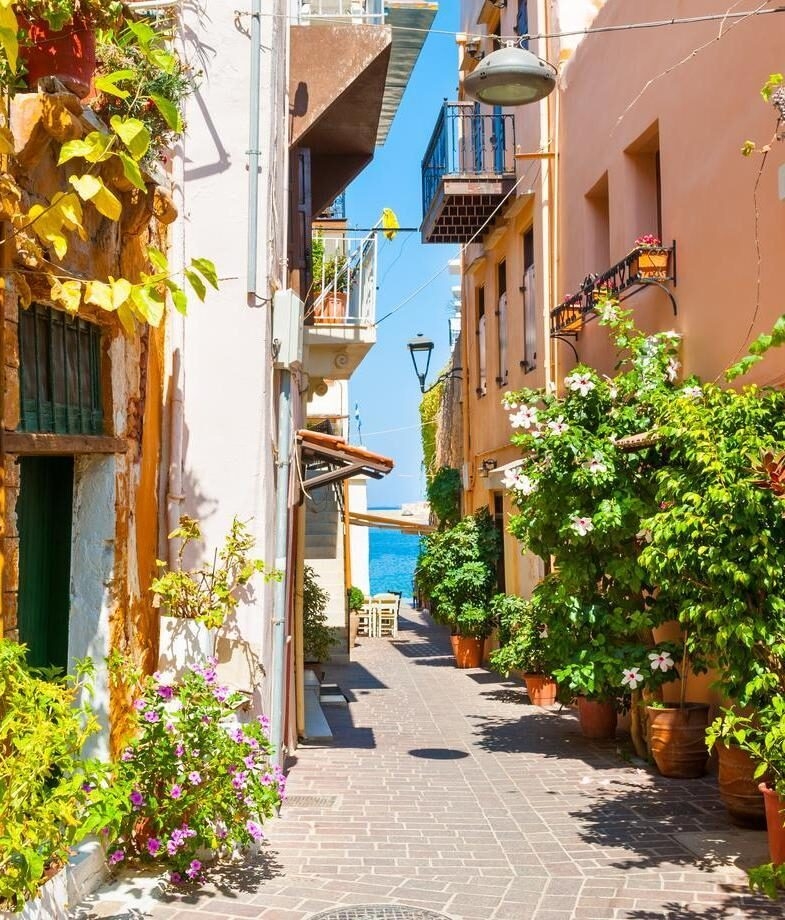 A sunlit alley in Chania’s old town in Greece and the vibrant costumes of the Venice Carnival in Italy.