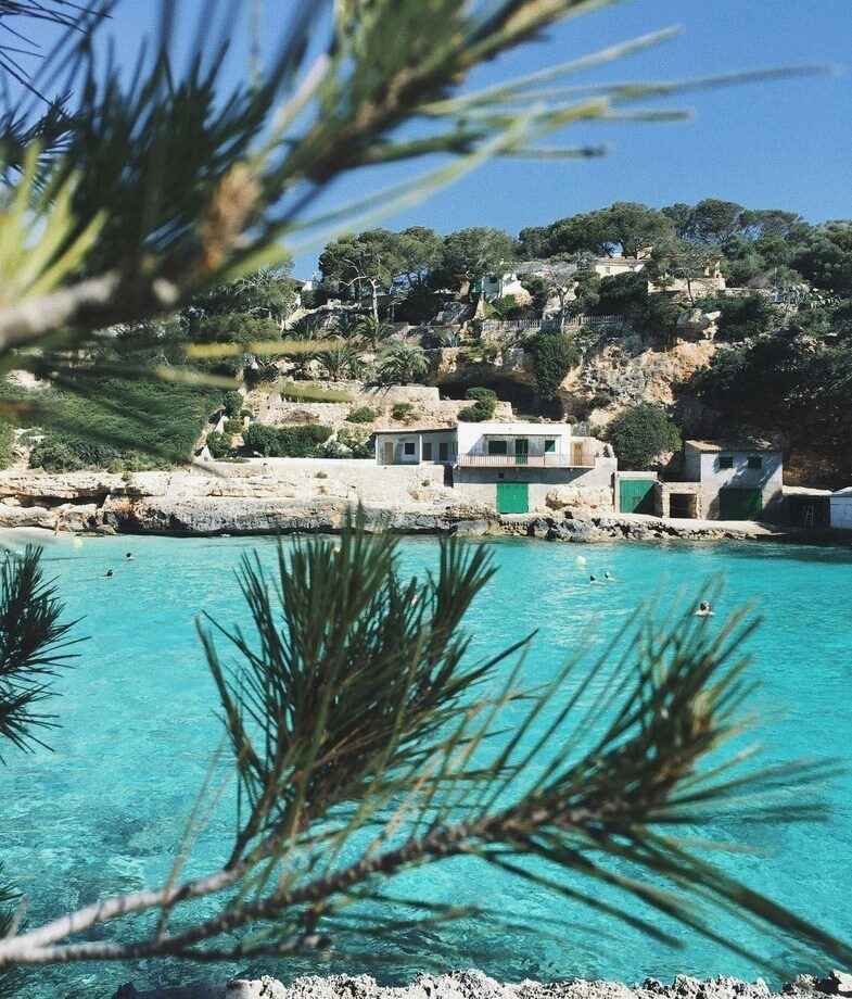 Turquoise waters along a quiet cove in Mallorca, Spain, and sunset views over Hvar’s harbour and islands in Croatia.
