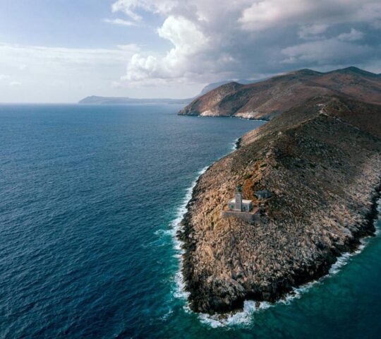 Aerial drone view of the rocky headland of Cape Tainaron and lighthouse, surrounded by the sea