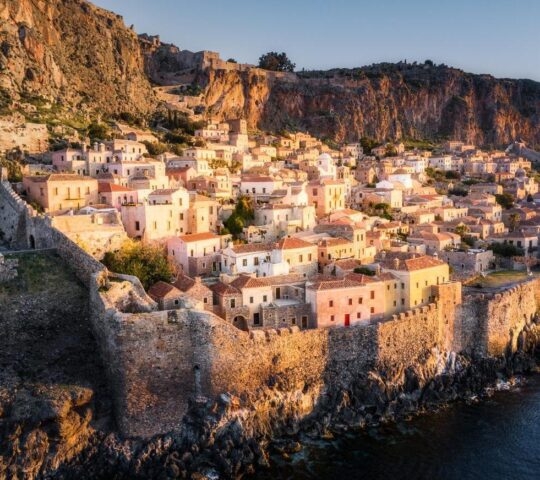 Houses in the walled town of Monemvasia glowing in the sunlight