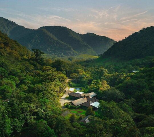 An aerial of El Silencio in Costa Rica with mountains surrounding the hotel on all sides.