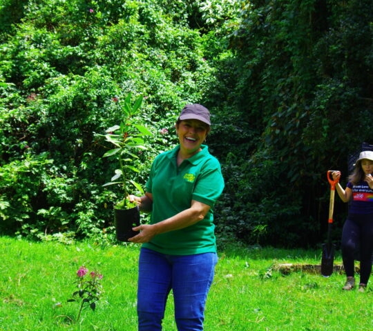 A woman happy after planting trees in Bosque Vivo Costa Rica
