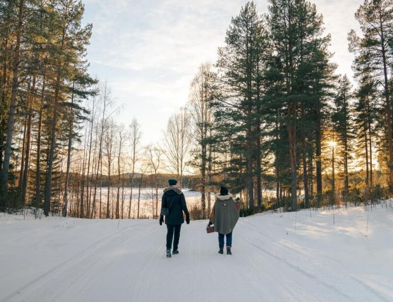 A person foraging with a member of the Sámi community in Northern Sweden.