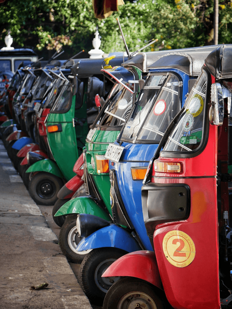 A colorful tuk-tuk navigating the historic streets of Kandy, offering a bespoke and authentic way to explore Sri Lanka’s cultural capital.