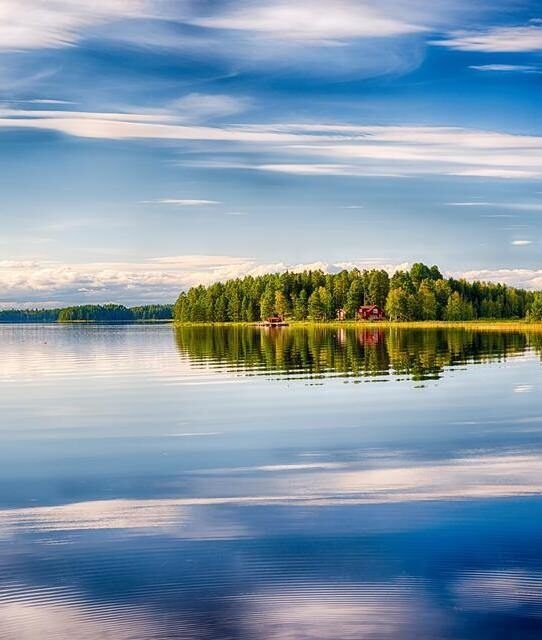 Swedish lake in the summer in motion as boat drives by the lake