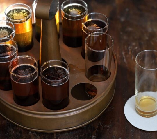 A tasting of Kölsch beer in a typical tray in brewery pub.
